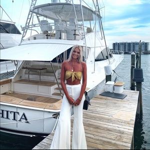 White flare trousers with slits.